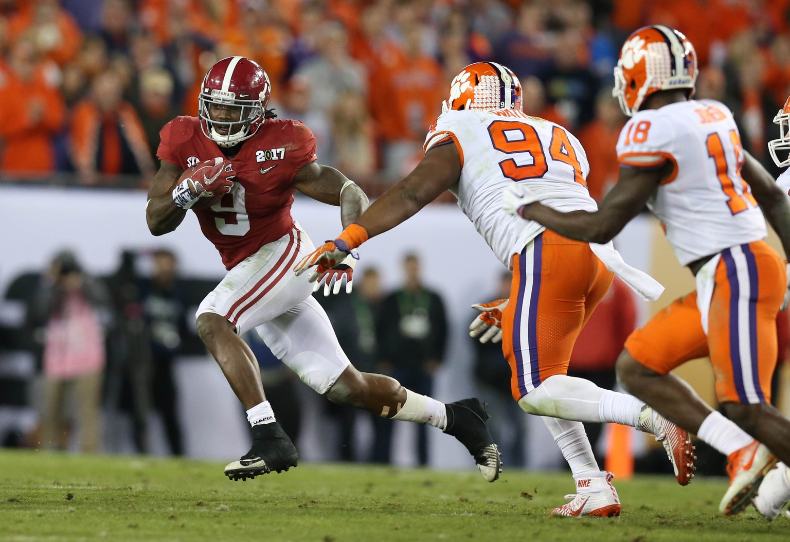 Jan 9, 2017; Tampa, FL, USA; Alabama Crimson Tide running back Bo Scarbrough (9) carries the ball past Clemson Tigers defensive tackle Carlos Watkins (94) in the 2017 College Football Playoff National Championship Game at Raymond James Stadium. Mandatory Credit: Matthew Emmons-USA TODAY Sports