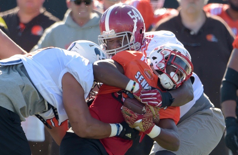 Jan 24, 2017; Mobile, AL, USA; South squad running back Matt Dayes of North Carolina State (20) is stopped by inside linebacker Harvey Langi of Brigham Young (left) and defensive tackle Dalvin Tomlinson of Alabama (54) during practice at Ladd-Peebles Stadium. Mandatory Credit: Glenn Andrews-USA TODAY Sports