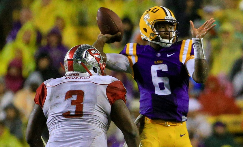 Oct 24, 2015; Baton Rouge, LA, USA; LSU Tigers quarterback Brandon Harris (6) passes as Western Kentucky Hilltoppers defensive lineman Jontavious Morris (3) defends during the second quarter of a game at Tiger Stadium. Mandatory Credit: Derick E. Hingle-USA TODAY Sports