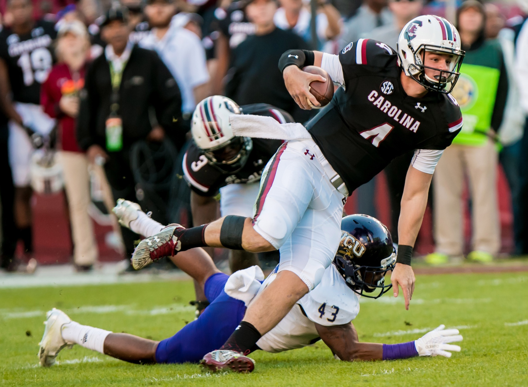 Nov 19, 2016; Columbia, SC, USA; South Carolina Gamecocks quarterback Jake Bentley (4) scrambles past Western Carolina Catamounts linebacker Kendall White (43) in the first quarter at Williams-Brice Stadium. Mandatory Credit: Jeff Blake-USA TODAY Sports