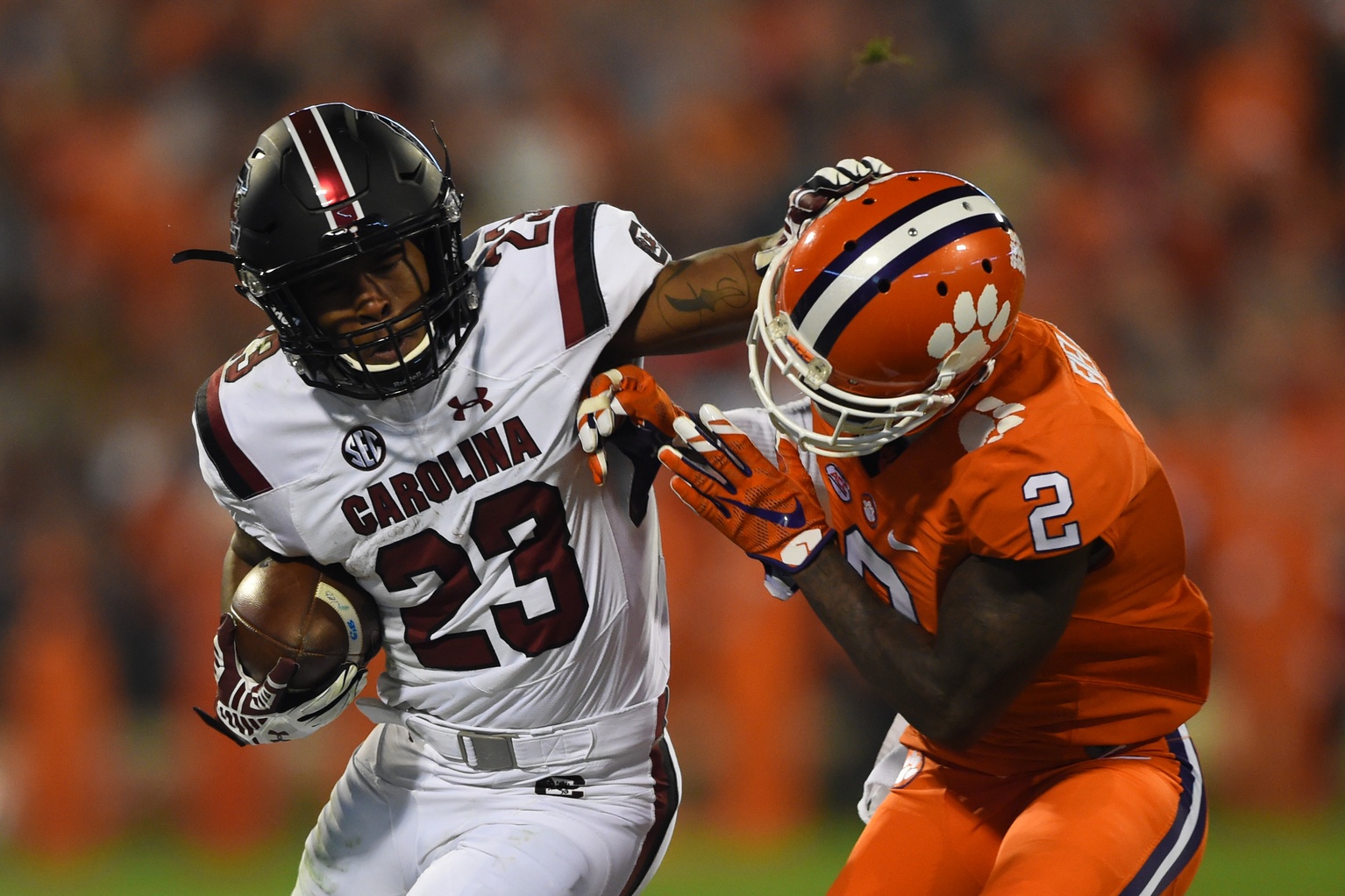 Nov 26, 2016; Clemson, SC, USA; South Carolina Gamecocks running back Rico Dowdle (23) stiff arms Clemson Tigers cornerback Mark Fields (2) during the fourth quarter at Clemson Memorial Stadium. Clemson Tigers defeated South Carolina Gamecocks 56-7. Mandatory Credit: Tommy Gilligan-USA TODAY Sports