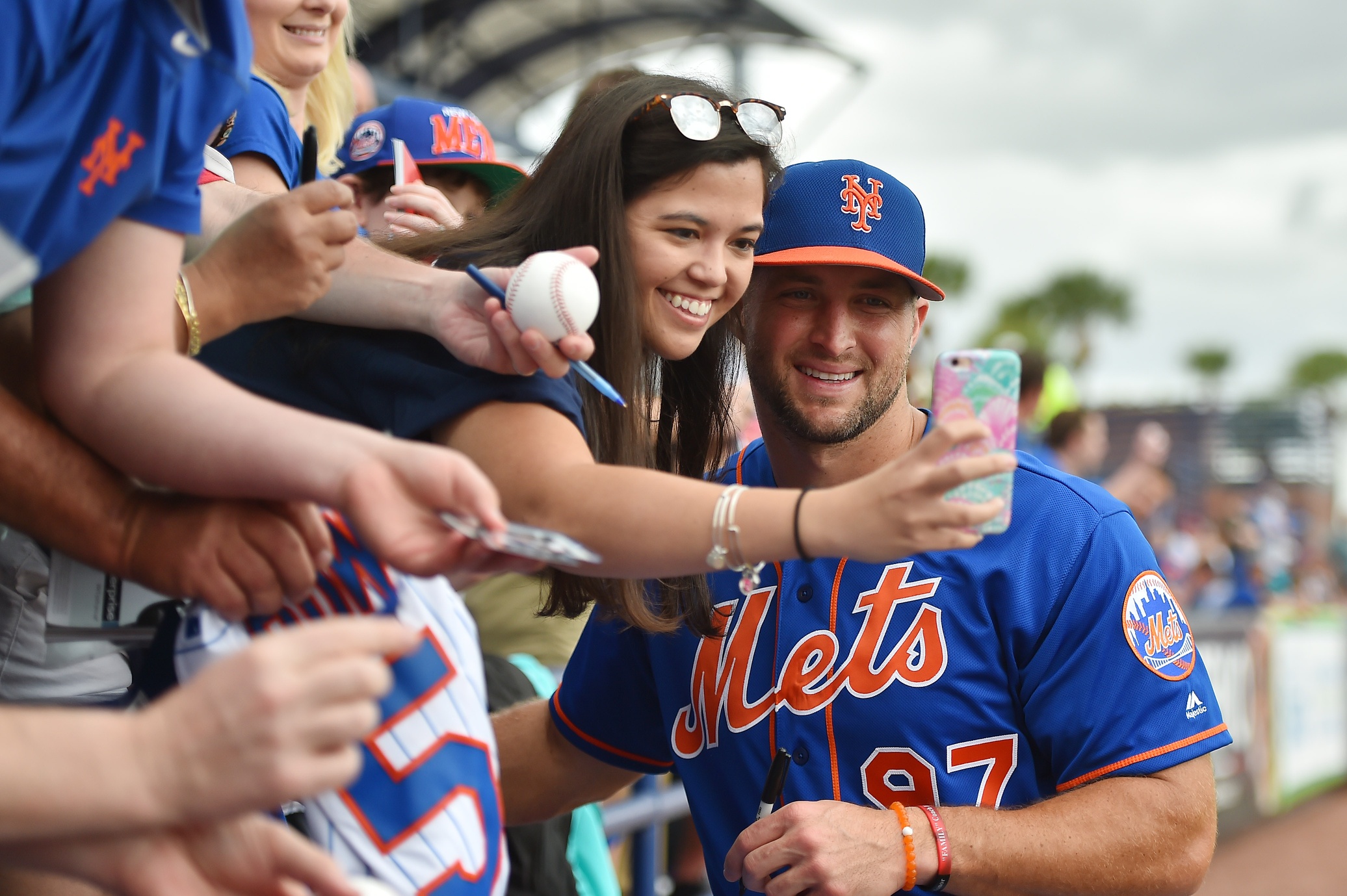 Mar 8, 2017; Port St. Lucie, FL, USA; New York Mets designated hitter Tim Tebow (97) takes a selfie picture with a fan prior to the game against the Boston Red Sox at First Data Field. Mandatory Credit: Jasen Vinlove-USA TODAY Sports