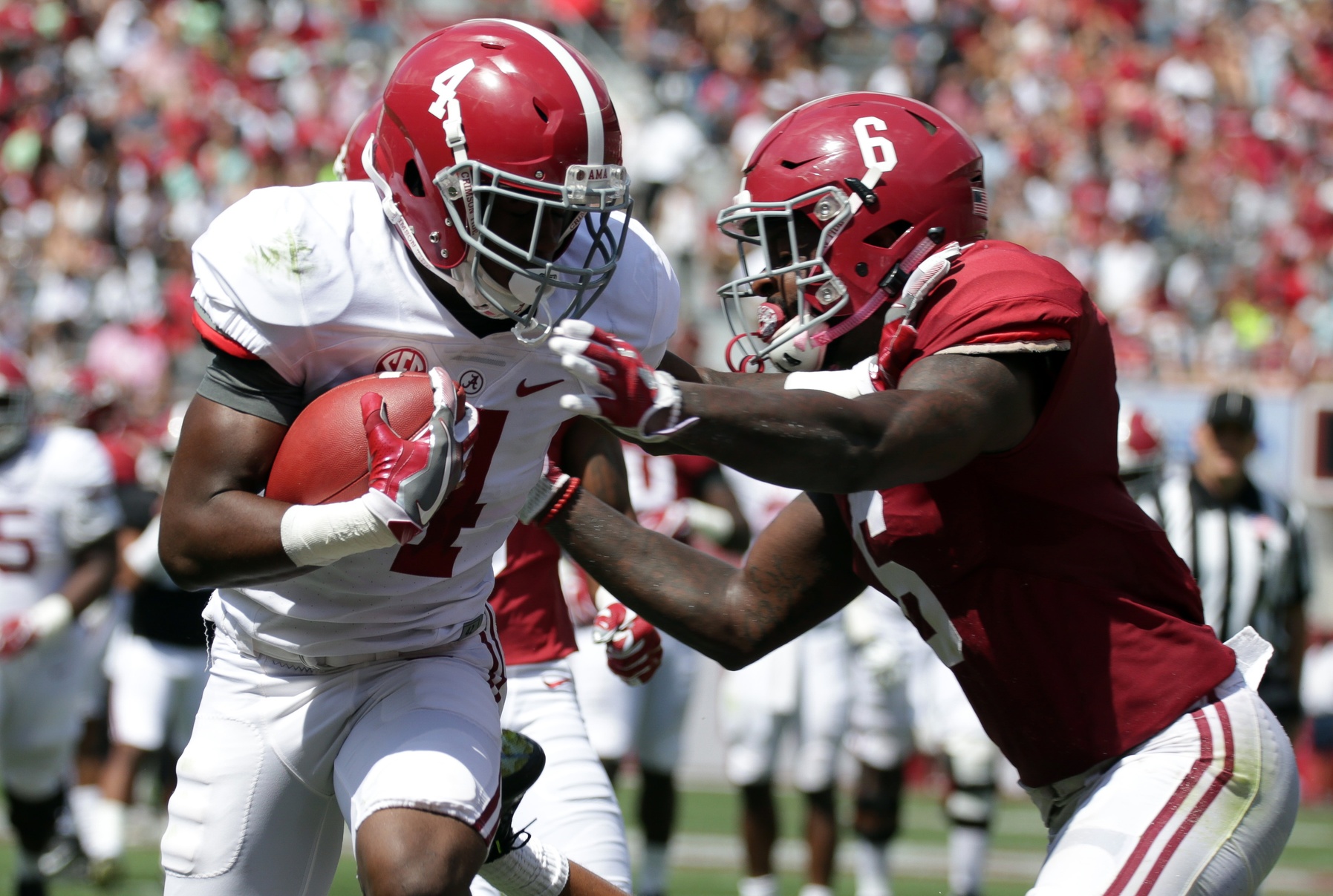 Apr 22, 2017; Tuscaloosa, AL, USA; Alabama Crimson Tide wide receiver Jerry Jeudy (4) is hit by Alabama Crimson Tide defensive back Hootie Jones (6) as he scores during the A-day game at Bryant Denny Stadium. Mandatory Credit: Marvin Gentry-USA TODAY Sports