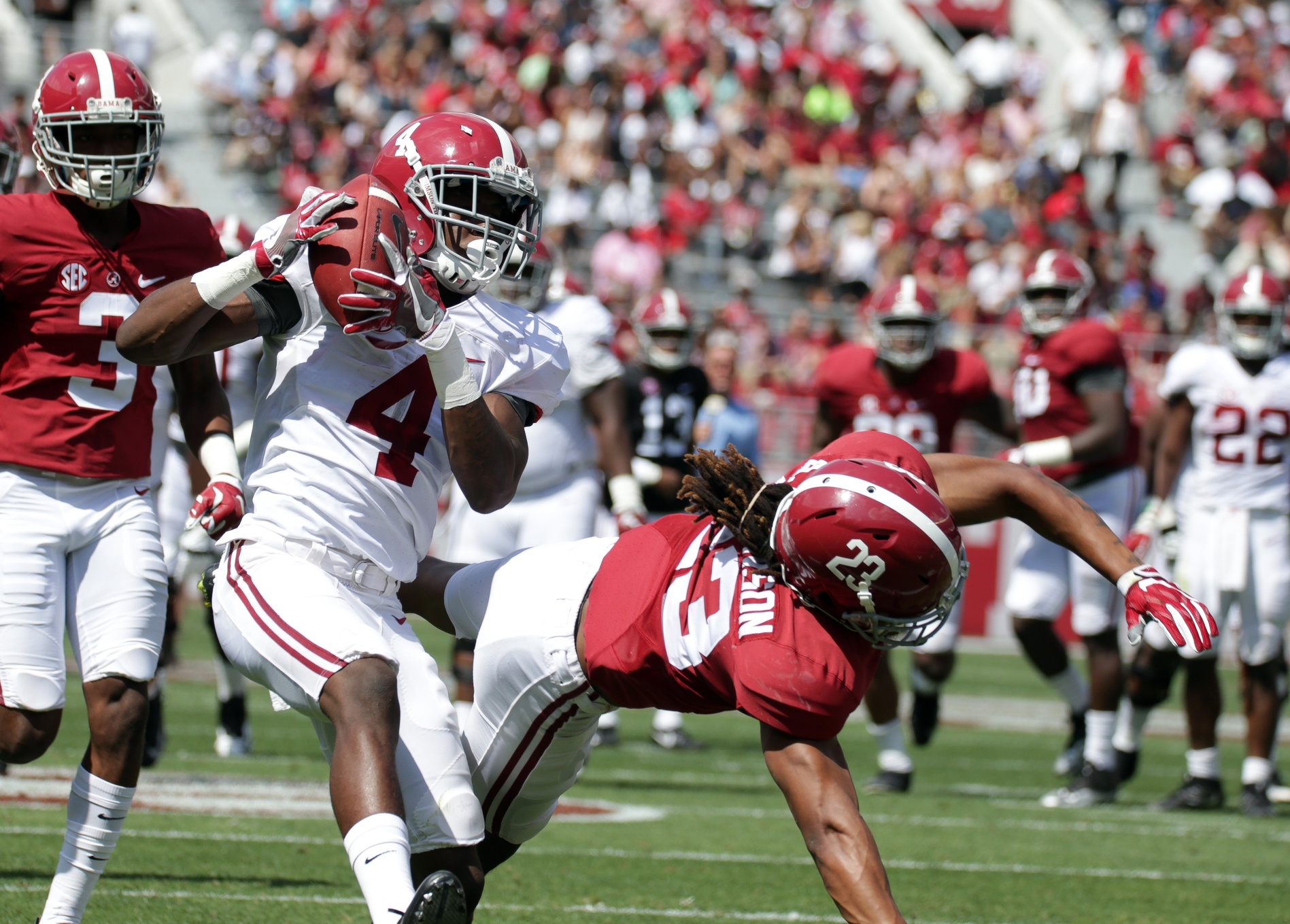 Apr 22, 2017; Tuscaloosa, AL, USA; Alabama Crimson Tide wide receiver Jerry Jeudy (4) goes up for the ball against Alabama Crimson Tide defensive back Aaron Robinson (23) for a score during the A-day game at Bryant Denny Stadium. Mandatory Credit: Marvin Gentry-USA TODAY Sports