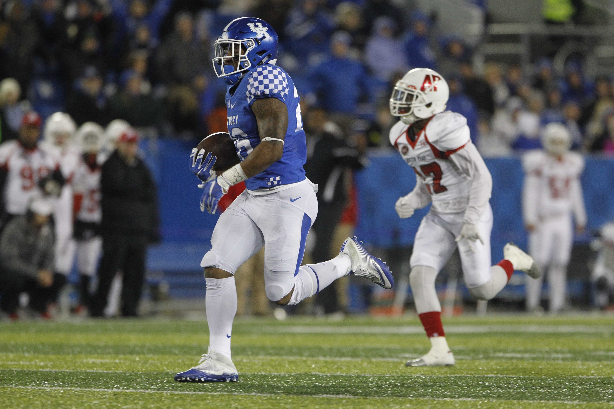 Nov 19, 2016; Lexington, KY, USA; Kentucky Wildcats running back Benny Snell (26) runs the ball against Austin Peay Governors defensive back Rodney Saulsberry (27) in the second half at Commonwealth Stadium. Kentucky defeated Austin Peay 49-13. Mandatory Credit: Mark Zerof-USA TODAY Sports