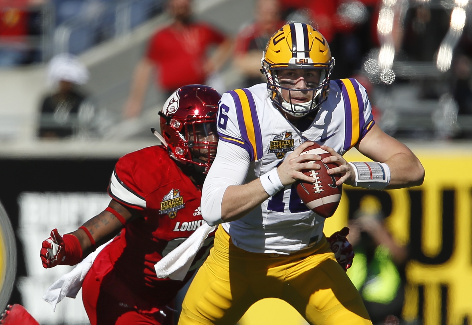 Dec 31, 2016; Orlando, FL, USA; LSU Tigers quarterback Danny Etling (16) is sacked by Louisville Cardinals linebacker Devonte Fields (92) during the first quarter of an NCAA football game in the Buffalo Wild Wings Citrus Bowl at Camping World Stadium. Mandatory Credit: Reinhold Matay-USA TODAY Sports