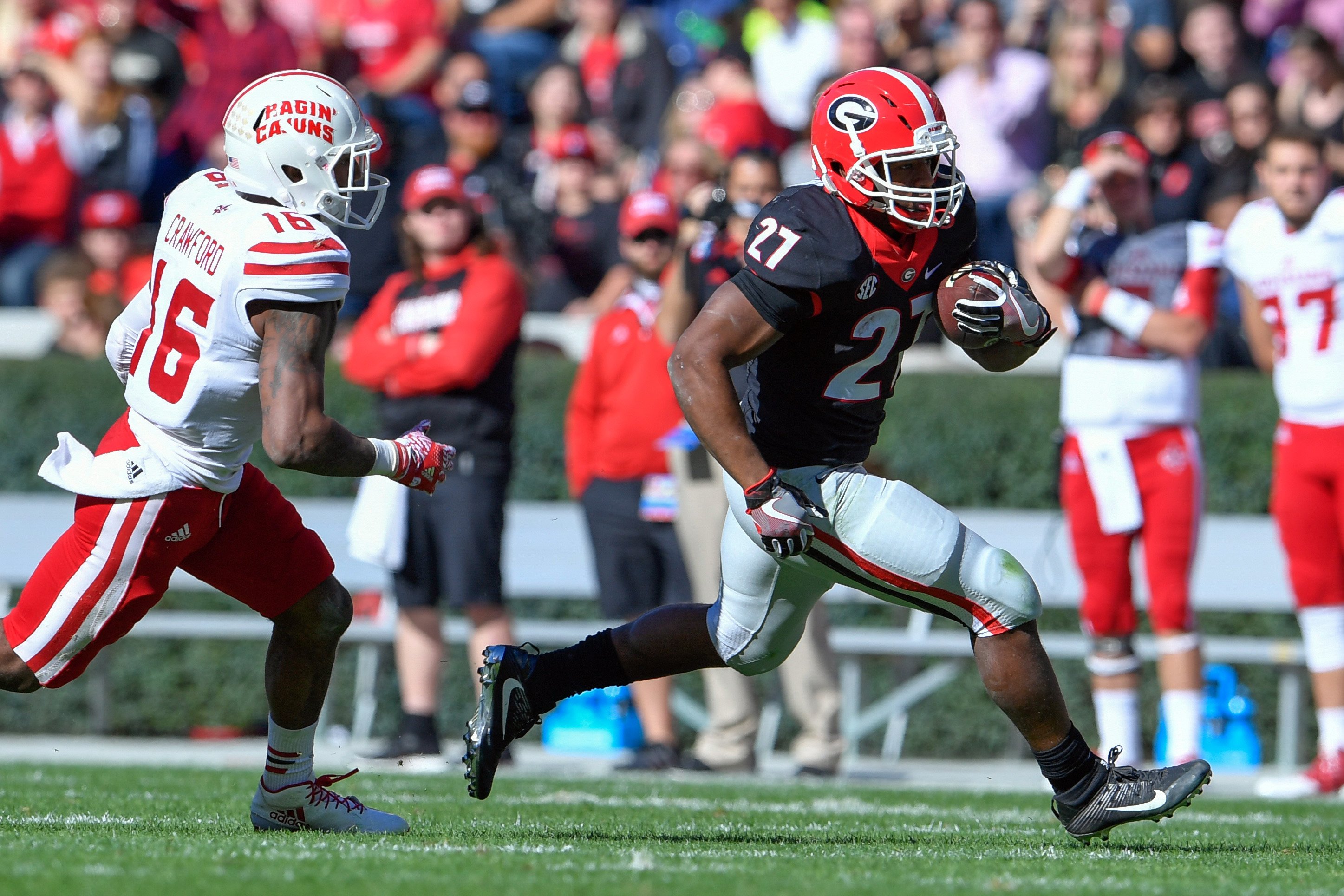 Nov 19, 2016; Athens, GA, USA; Georgia Bulldogs running back Nick Chubb (27) runs past Louisiana-Lafayette Ragin Cajuns defensive back Travis Crawford (16) during the first half at Sanford Stadium. Mandatory Credit: Dale Zanine-USA TODAY Sports