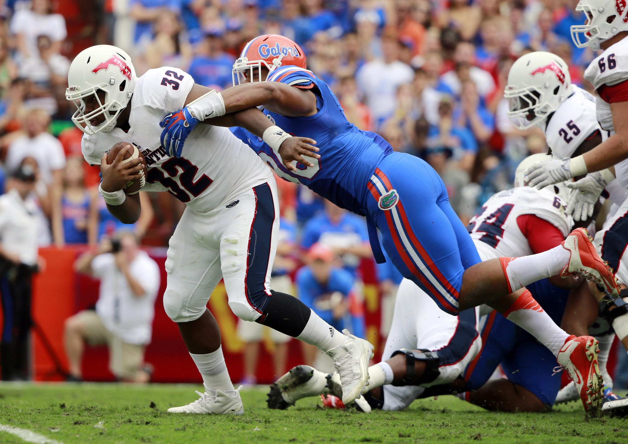 Nov 21, 2015; Gainesville, FL, USA; Florida Gators defensive lineman Cece Jefferson (96) tackles Florida Atlantic Owls quarterback Jaquez Johnson (32) during the second quarter at Ben Hill Griffin Stadium. Mandatory Credit: Kim Klement-USA TODAY Sports