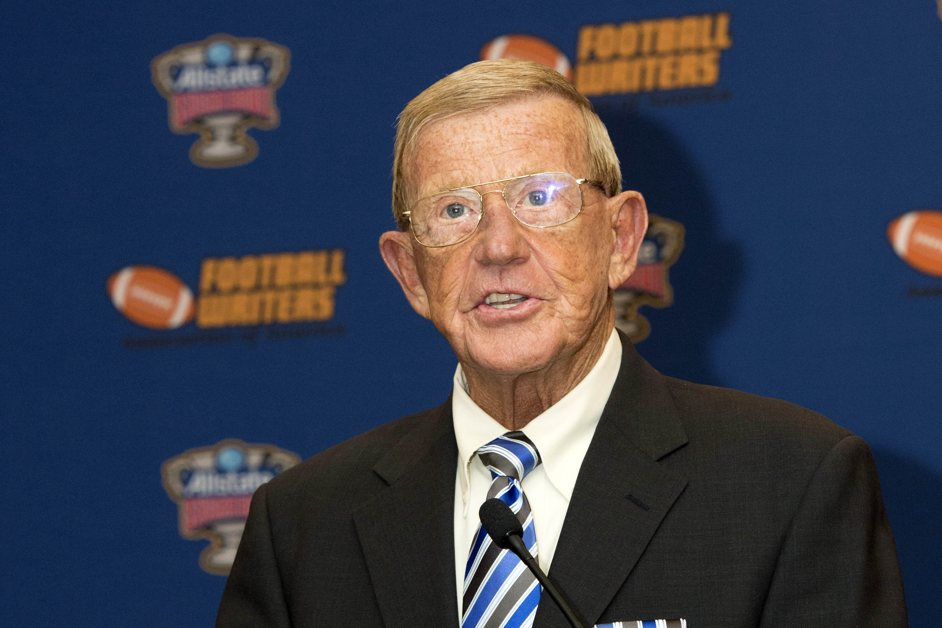 Lou Holtz speaks at a press conference.