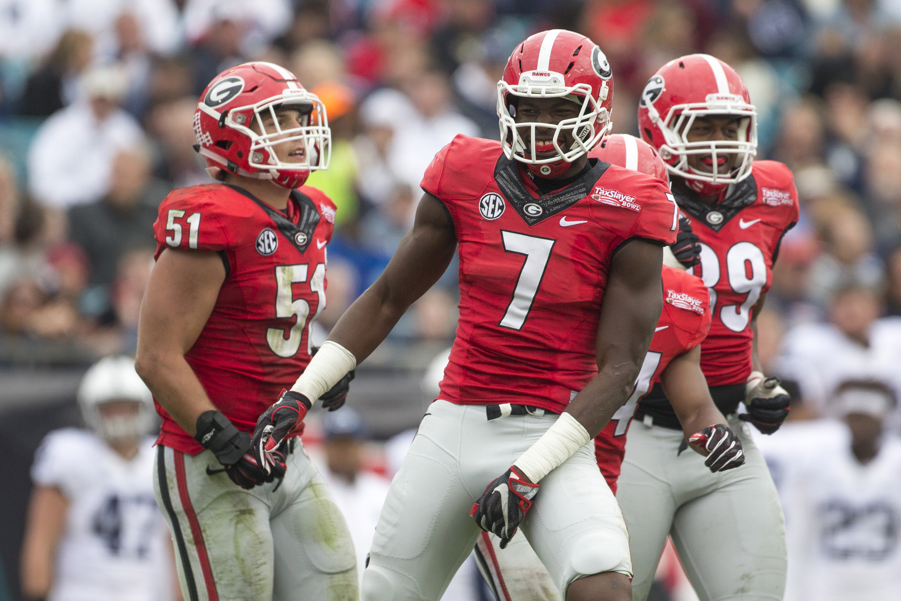 Lorenzo Carter celebrates a tackle.