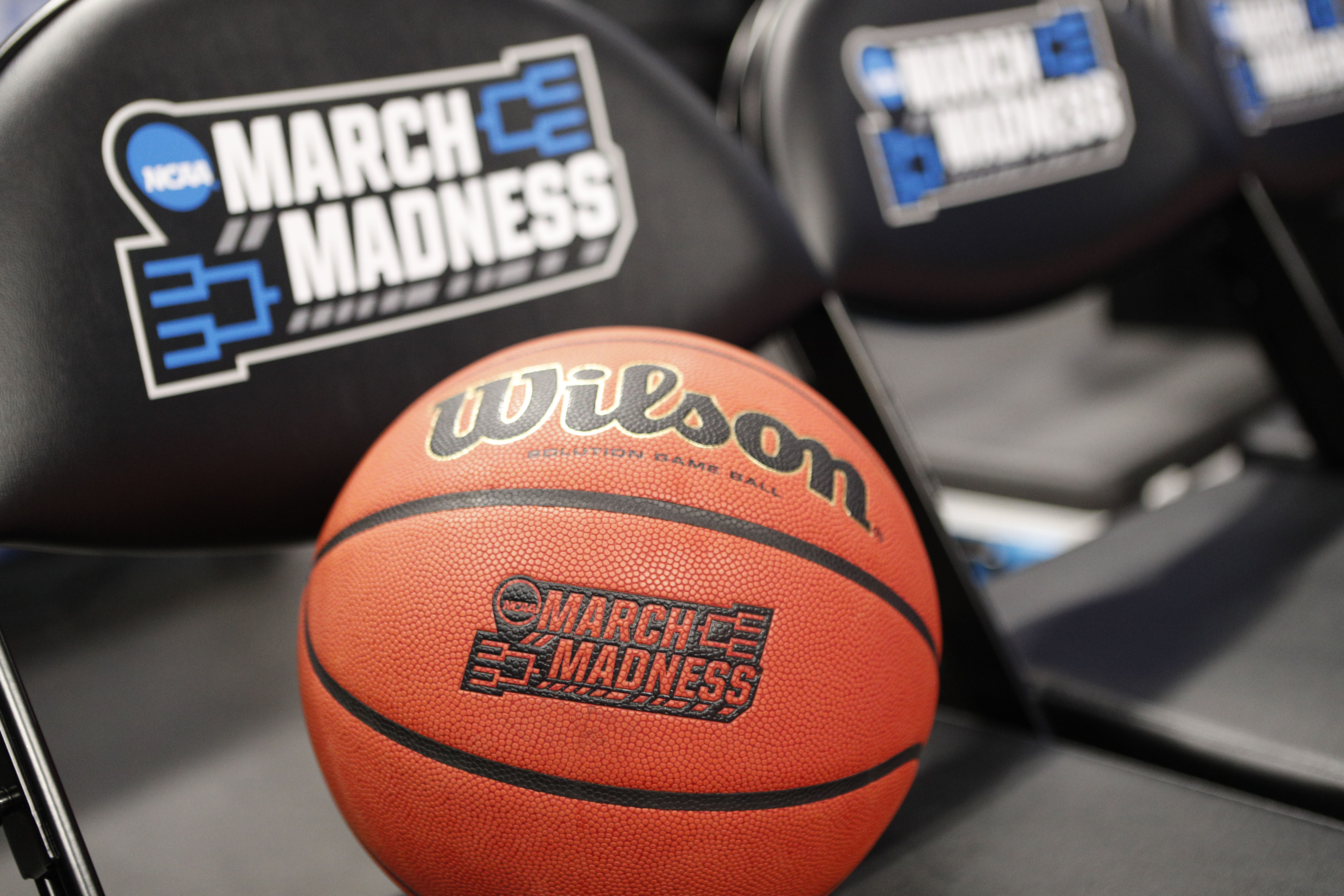 A March Madness basketball sitting on a chair.