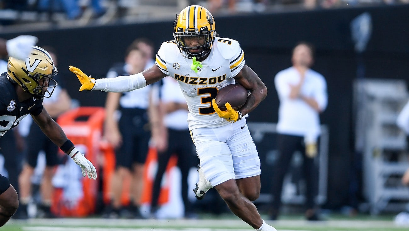 Luther Burden of the Missouri Tigers runs away from a Vanderbilt defender.