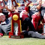 Oklahoma softball coach Patty Gasso poses with a National Championship trophy in 2021.