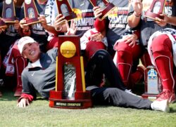 Oklahoma softball coach Patty Gasso poses with a National Championship trophy in 2021.