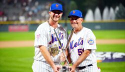 Pete Alonso and New York Mets bench coach Dave Jauss pose with the Home Run Derby trophy after the Mets' slugger won the title in 2021.