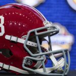 An Alabama football helmet sits on a table during SEC Media Days in 2022.