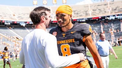 Tennessee QB Nico Iamaleava hugs his OC, Joey Halzle after the Vols' blowout win over Chattanooga.