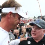 Ole Miss head coach Lane Kiffin talks to Kentucky head coach Mark Stoops.