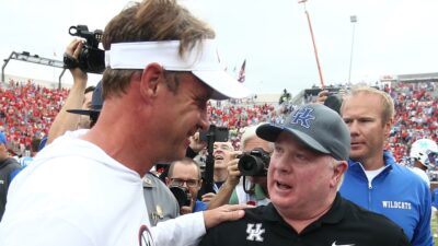 Ole Miss head coach Lane Kiffin talks to Kentucky head coach Mark Stoops.