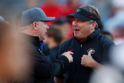 Kentucky coach Mark Stoops talks to Georgia coach Kirby Smart.