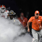Clemson coach Dabo Swinney leads his team onto the field.