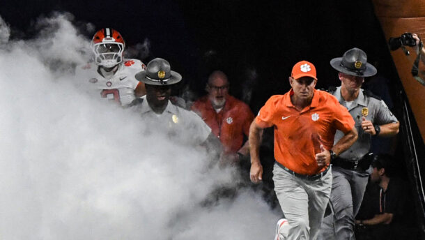 Clemson coach Dabo Swinney leads his team onto the field.