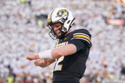 Brady Cook of the Missouri Tigers celebrates after scoring a touchdown against Buffalo.