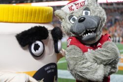 NC State's mascot poses with the Dukes Mayo mascot before a game against Tennessee.