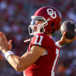 Oklahoma QB Jackson Arnold warms up on the sidelines.