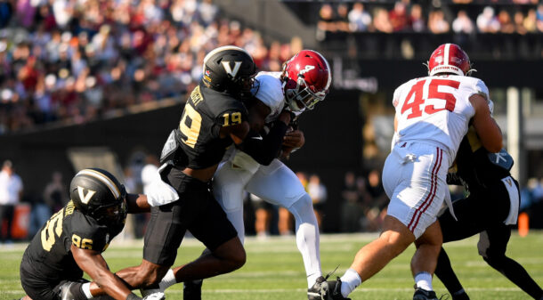 Jalen Milroe gets tackled by a Vanderbilt player.