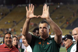 Miami coach Mario Cristobal flashes the U sign.