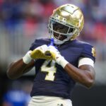 Jeremiyah Love celebrates after scoring a touchdown.