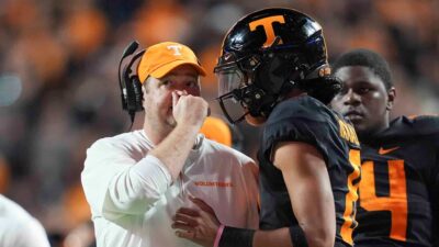 Josh Heupel talks to Nico Iamaleava during a game.