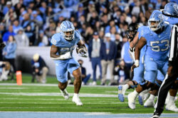 Omarion Hampton runs the ball in a game in 2024.