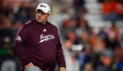 Mike Elko watches his Texas A&M squad warm up before a game at Auburn.