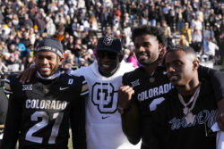 Colorado head coach Deion Sanders with his sons Shilo and Shedeur.