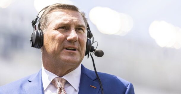 Dan Mullen wears a headset.