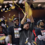 Kirby Smart raises the national title trophy.