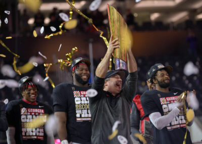 Kirby Smart raises the national title trophy.
