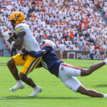 Keionte Scott is shown making a tackle.