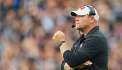 Barry Odom watches his UNLV team play during a game against Kansas in 2024.