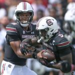 Rocket Sanders get a handoff for South Carolina.