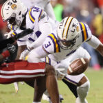 LSU DB Sage Ryan makes a hit.