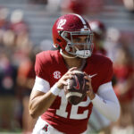 Dylan Lonergan warms up before an Alabama football game