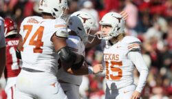 Texas kicker Bert Auburn celebrates with teammates after making a kick for the Longhorns against Arkansas.