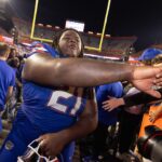Florida defensive lineman Desmond Watson is shown with fans.