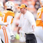 Josh Heupel meets Tennessee players as they leave the field.