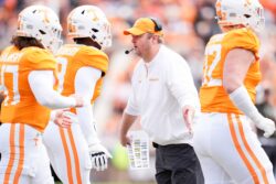 Josh Heupel meets Tennessee players as they leave the field.
