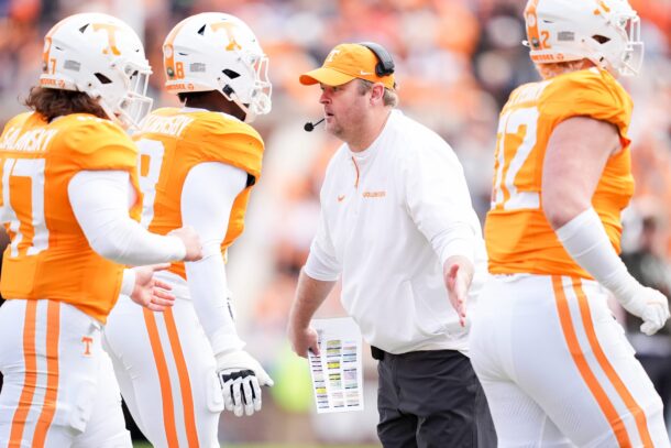 Josh Heupel meets Tennessee players as they leave the field.