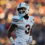 Mississippi State WR Kevin Coleman Jr. smiles on the field.